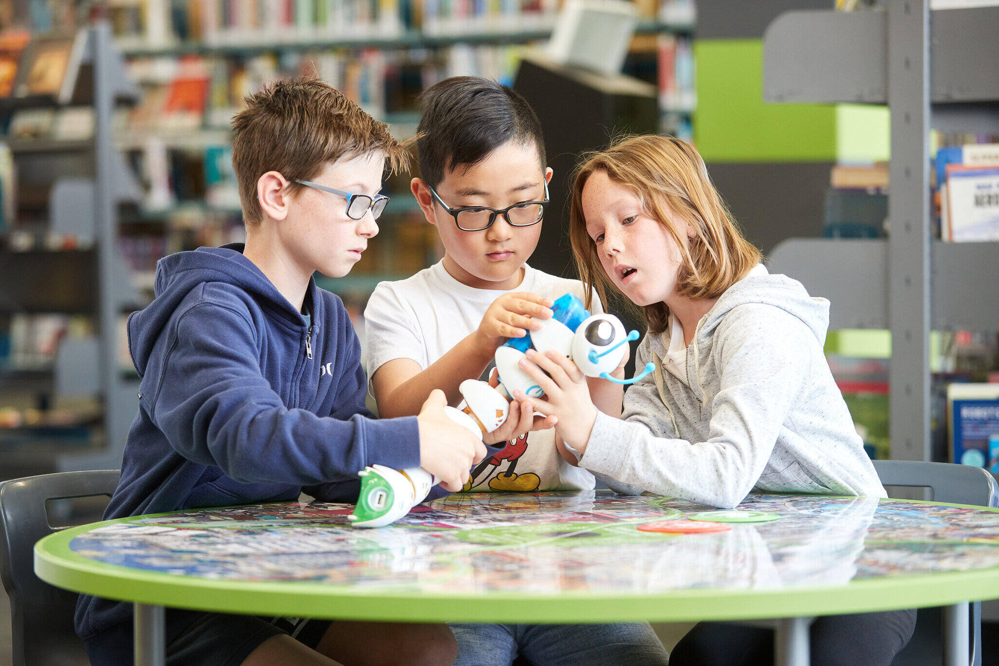 3 children handle a robot