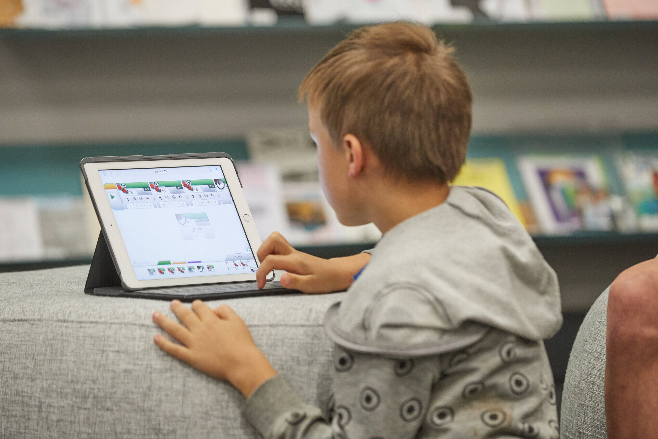 boy looks at internet on tablet