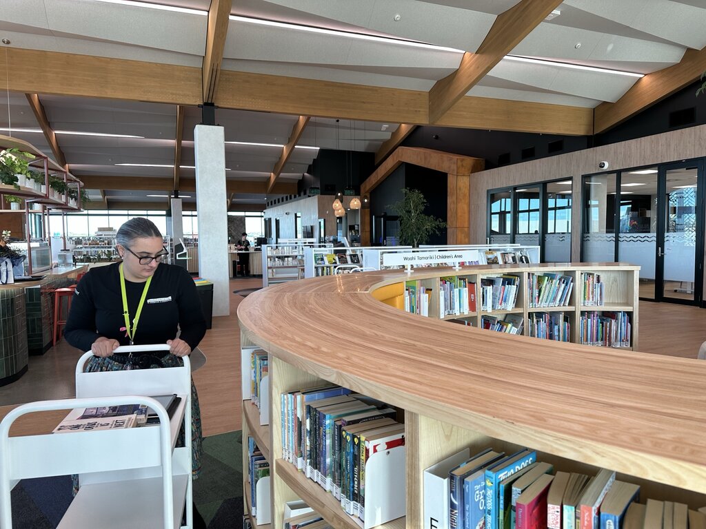 Library staff member shelving books