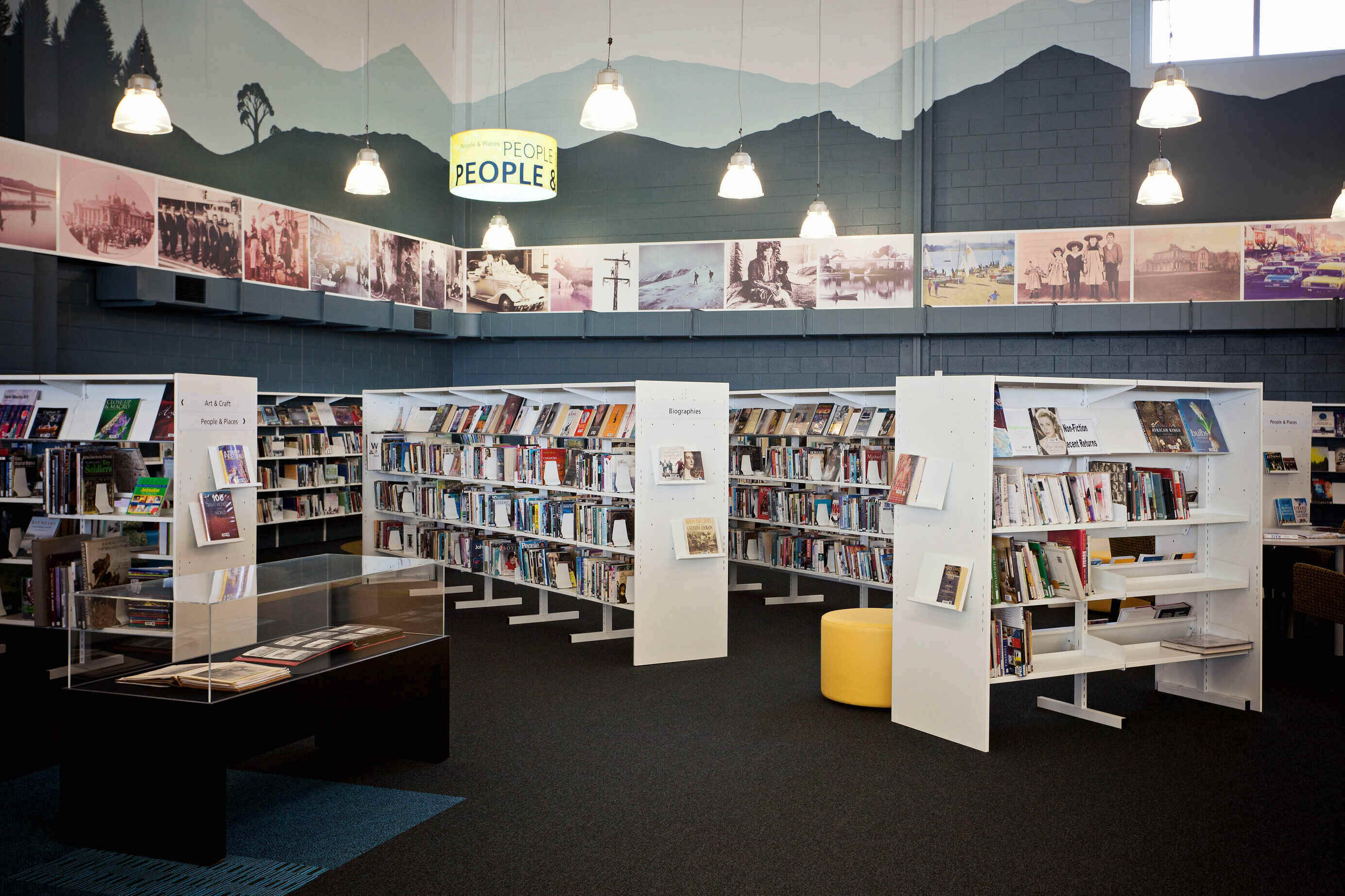 Image of library shelves with books and mural