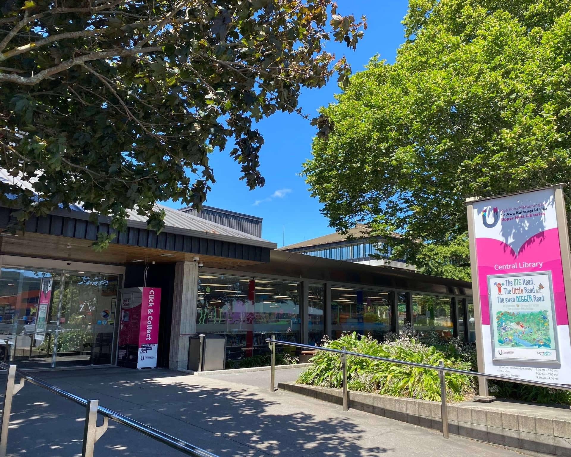 Image showing the entrance to Upper Hutt Library. It has a gentle slope with handrails leading to the automatic doors.